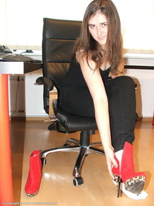 Taking Off Red Boots And Ankle Socks At A Desk